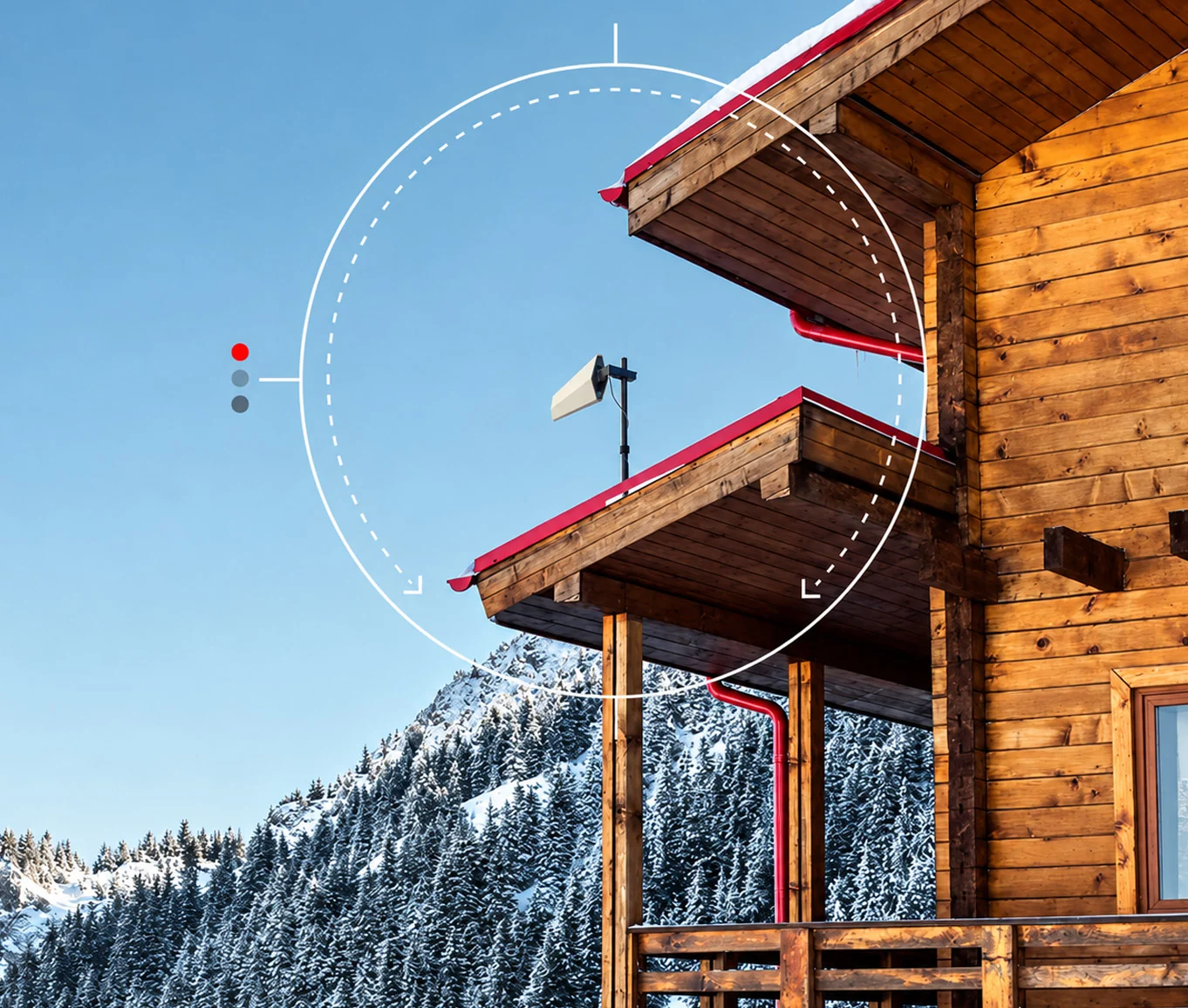 Cellular booster antenna on a mountain cabin (2026) Mountain cabin with a cellular signal booster antenna mounted on the roof, snowy forested mountains in the background